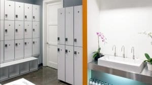 Two sections of high gloss laminate lockers with aluminum edge banding to the left and sink to the right.