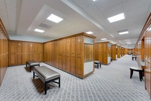 Woodmont Country Club's locker room with multiple wood locker bays, each bay has a mirror on the side.