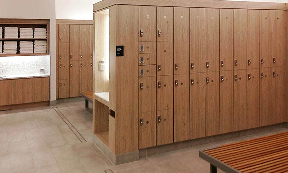 Textured laminate lockers inside locker room, benches, and matching grooming station and towel drop.